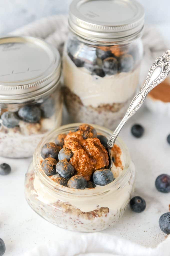quinoa parfait topped with blueberries and almond butter