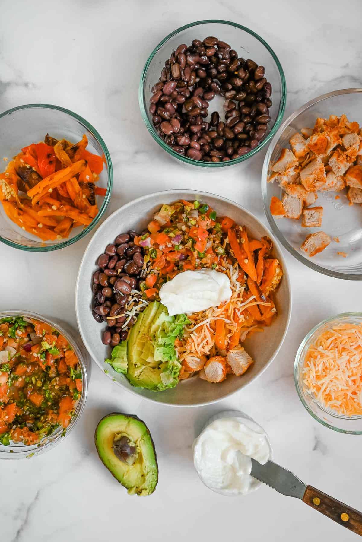 healthy chipotle chicken copycat bowl with toppings