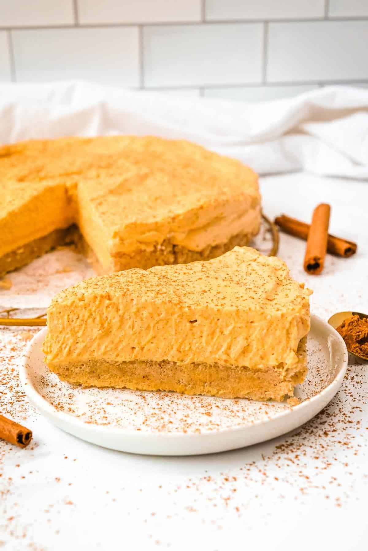 slice of healthy pumpkin cheesecake on a white plate.