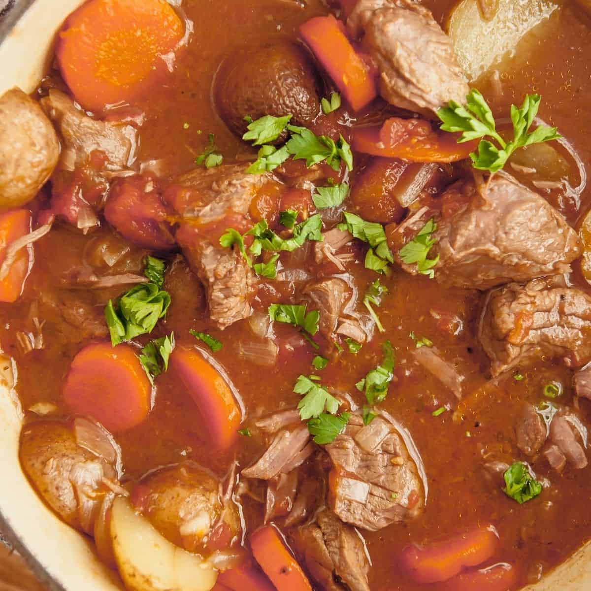 whole30 beef stew with potatoes, carrots and onions in a dutch oven