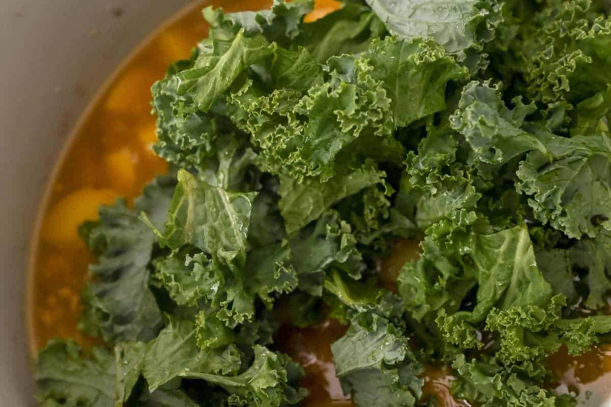 close up of kale in soup.