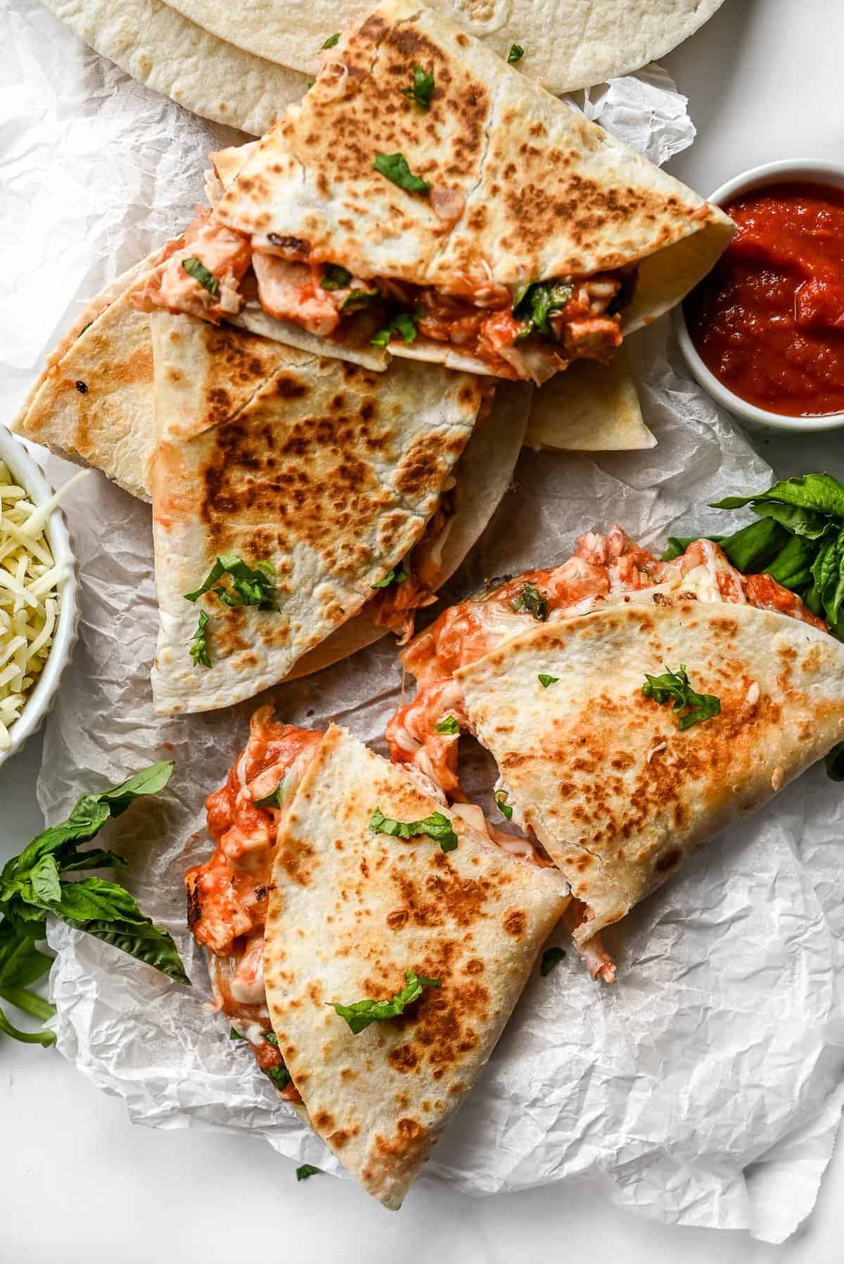 plate of italian quesadillas topped with basil