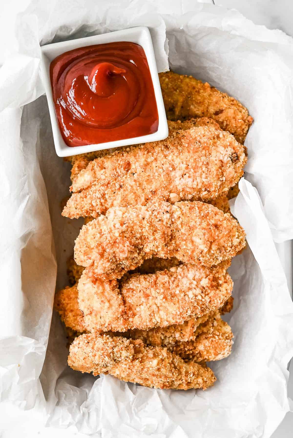 basket of crispy air fryer chicken tenders with ketchu