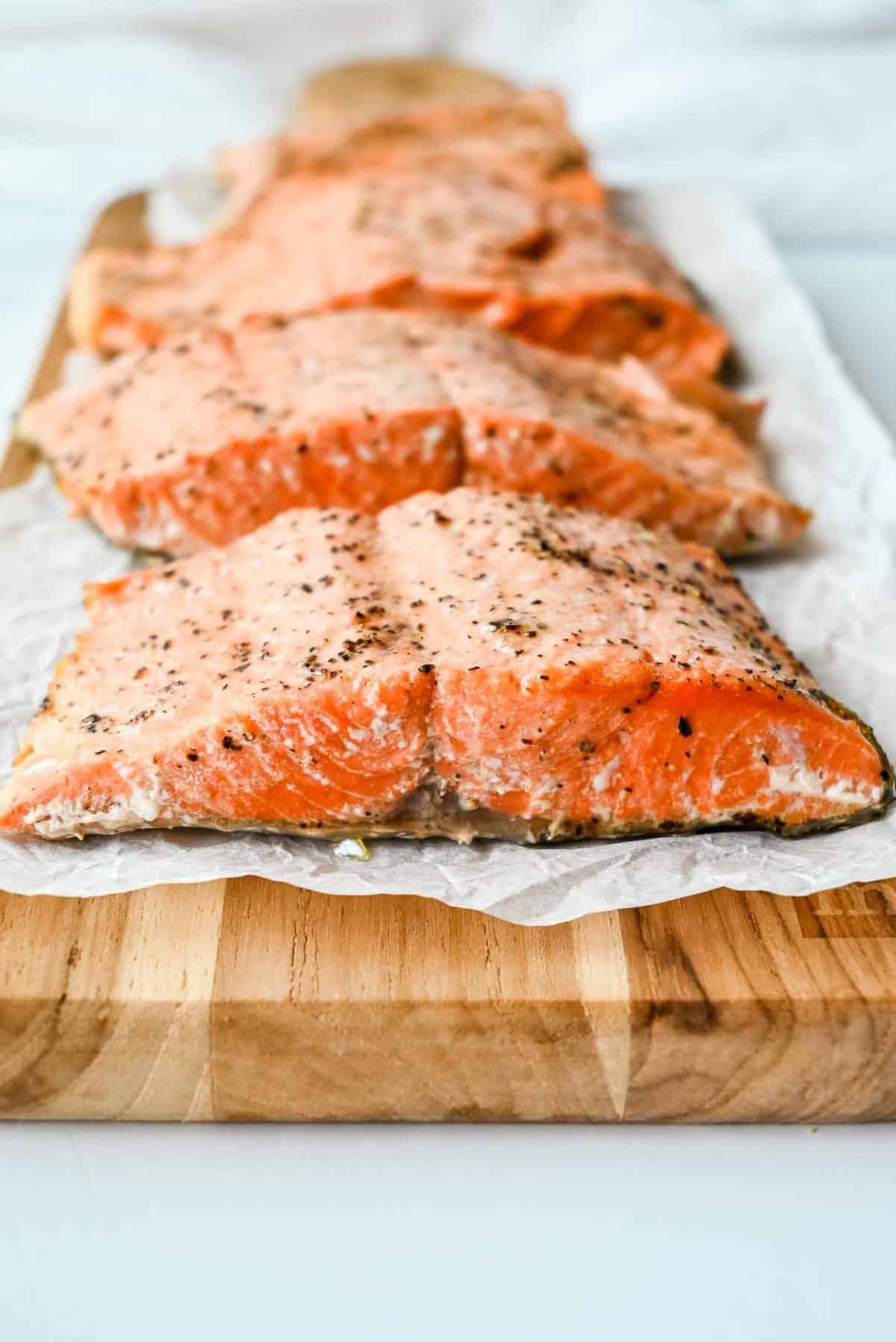 cooked air fryer salmon with skin on a wood slab