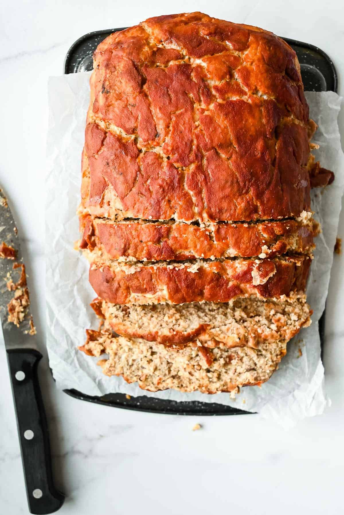 meatloaf without breadcrumbs in slices on a piece of parchment paper
