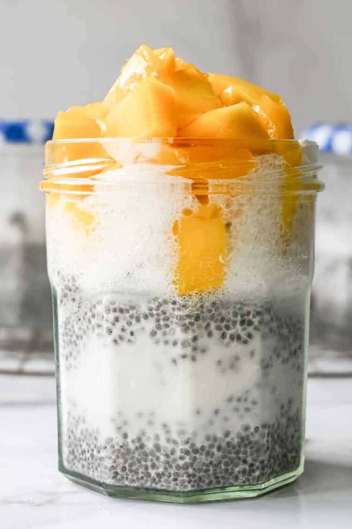 jar of chia pudding topped with mango.