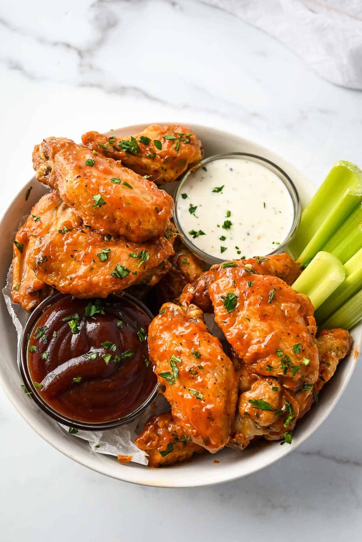 bowl of chicken wings with ranch and bbq