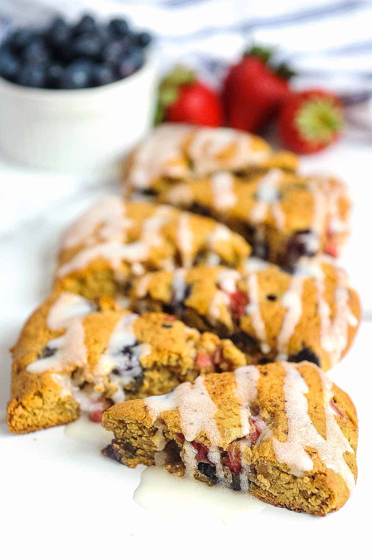 almond flour scones on a white plate with drizzle