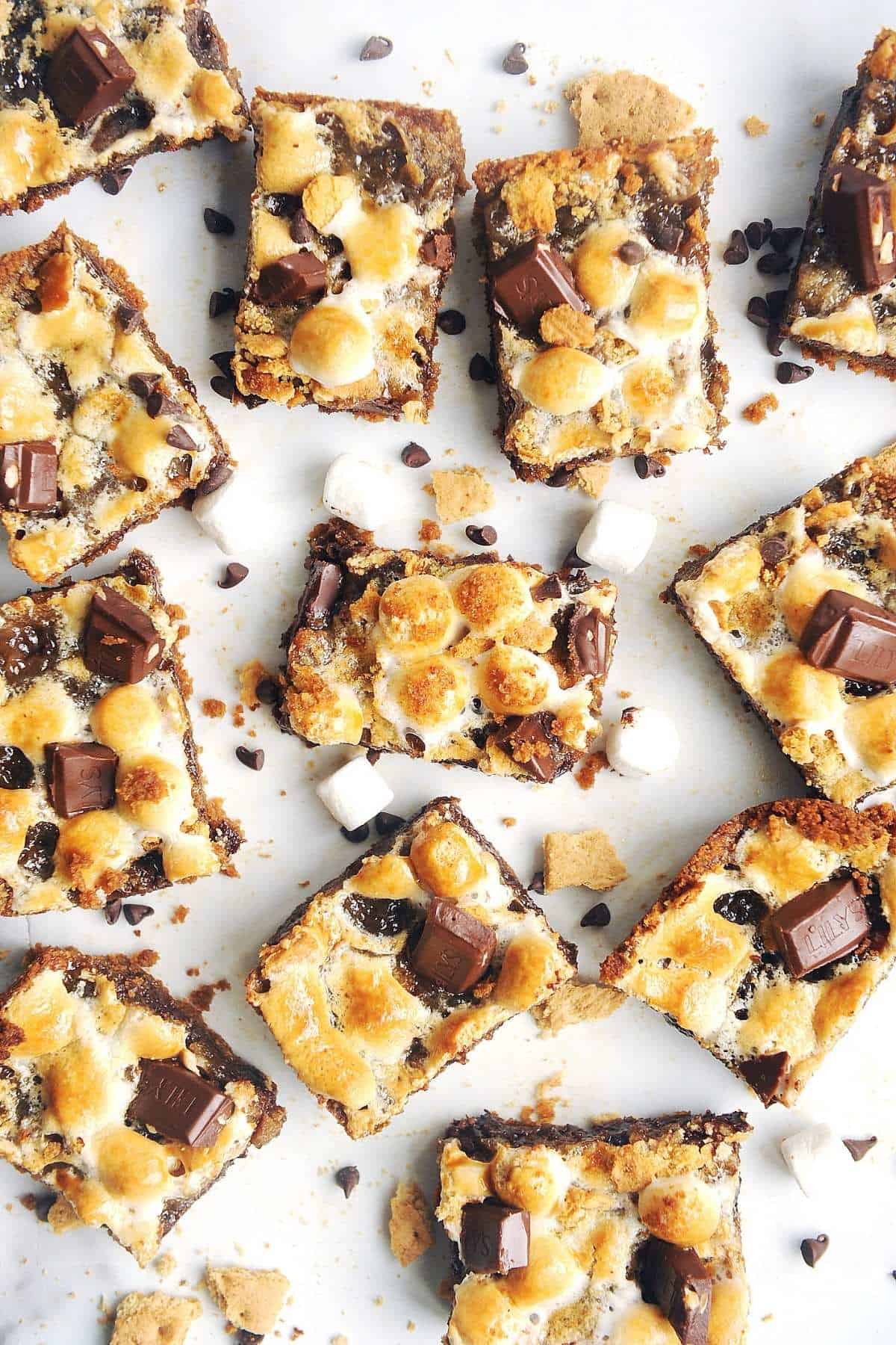smores bars on a white background with marshmallows and chocolate chips.