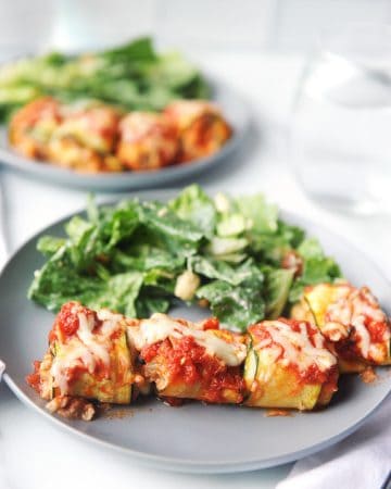 This easy keto zucchini lasagna rolls recipe is a family friendly dinner! Zucchini slices rolled around sausage, cheese, garlic and basil is a healthy summer dinner your family will love! #zucchini #lasagna #lowcarb #dinner