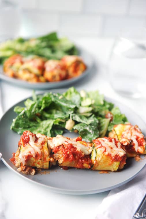 This easy keto zucchini lasagna rolls recipe is a family friendly dinner! Zucchini slices rolled around sausage, cheese, garlic and basil is a healthy summer dinner your family will love! #zucchini #lasagna #lowcarb #dinner