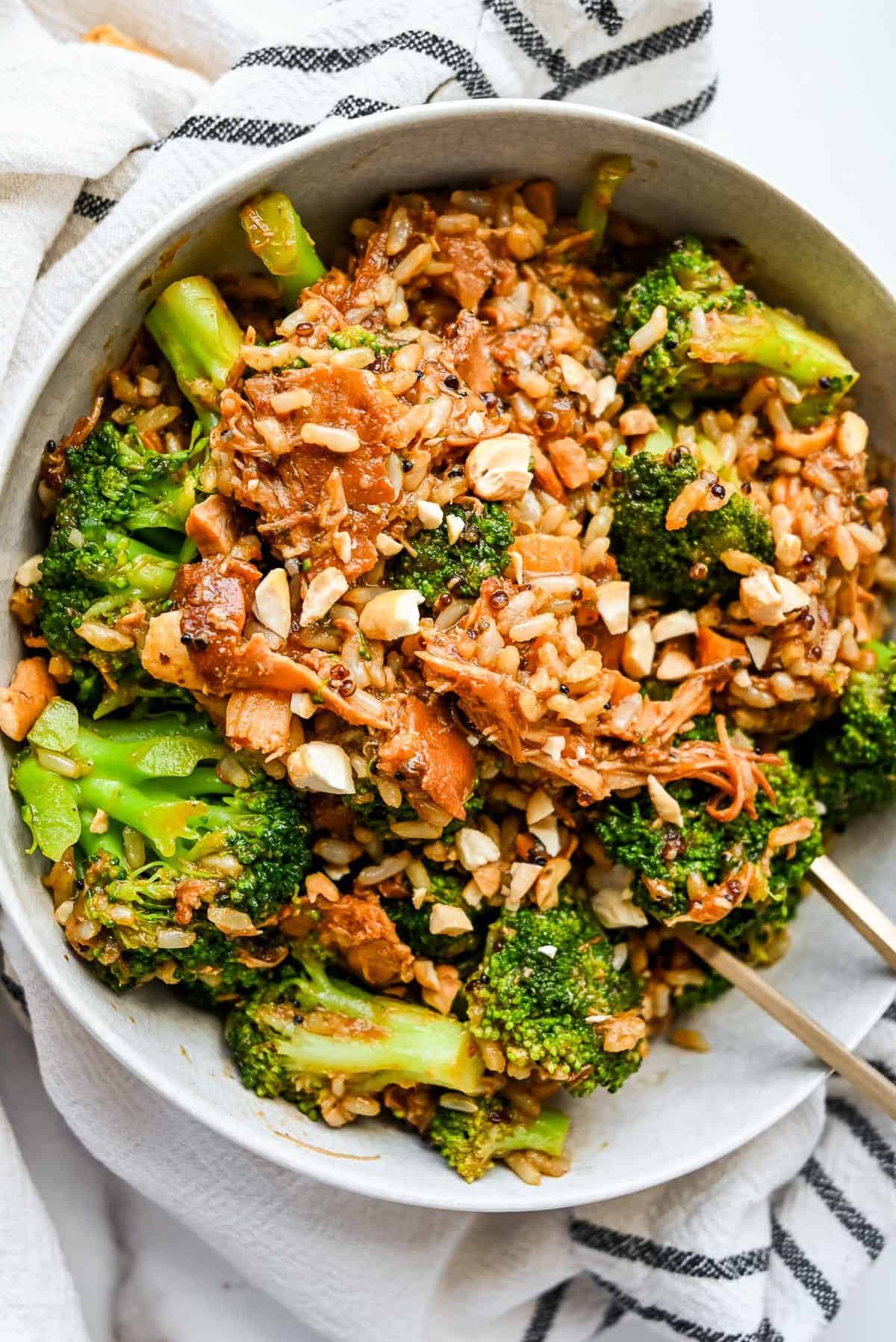 large bowl of paleo crock pot chicken thighs with broccoli rice and cashews