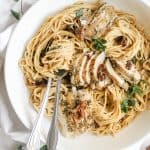 crockpot tuscan chicken pasta made with creamy dairy free cashew alfredo sauce in the slow cooker. Healthy and easy to make in the crock pot with spinach, sun-dried tomatoes and coconut milk. Serve with chickpea pasta or on its own for a whole30 or keto crockpot tuscan chicken.