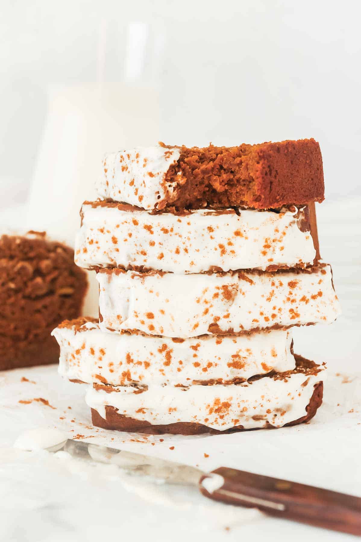 stack of healthy gingerbread loaf slices with cream cheese frosting