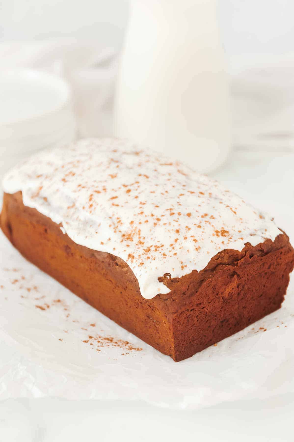 full loaf of healthy gingerbread with cream cheese frosting