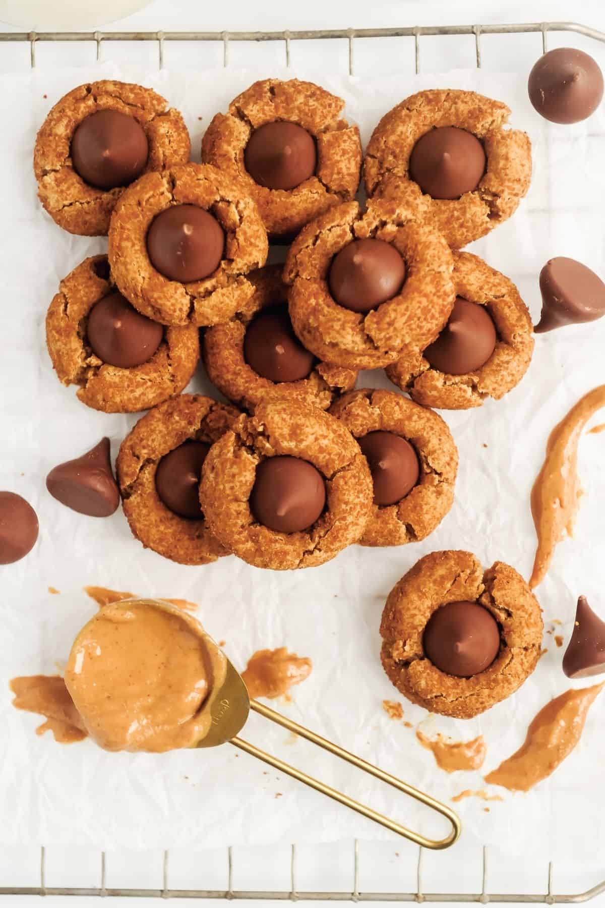 These healthier peanut butter blossoms are a Hershey kiss cookie recipe that is gluten free and easy to make.  Perfect for Christmas cookie exchanges or to freeze and serve for holiday guests.