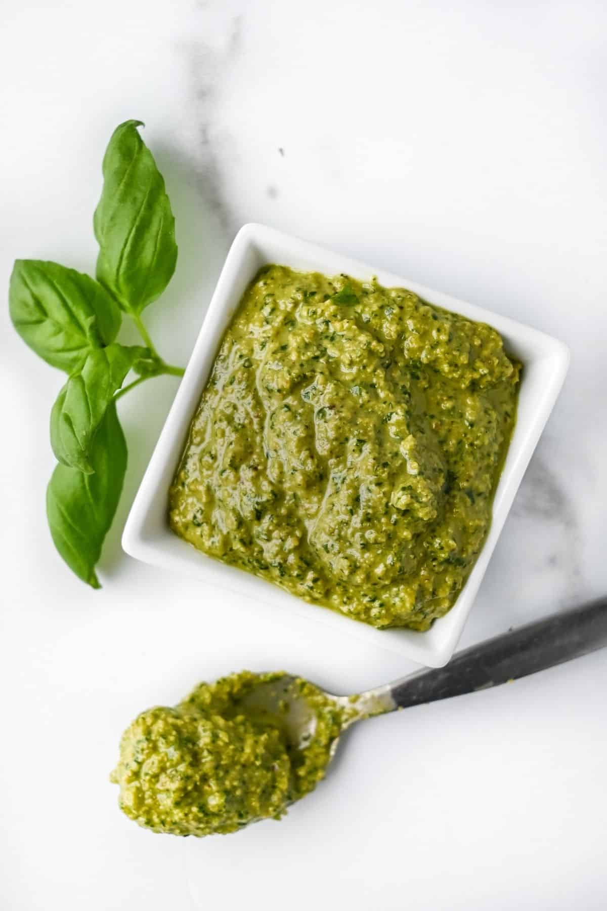 pesto without pine nuts with a spoonful of pesto and fresh basil