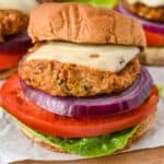 featured image close up shot of air fryer turkey burgers topped with swiss cheese and with a bun, lettuce, tomato, and onion.
