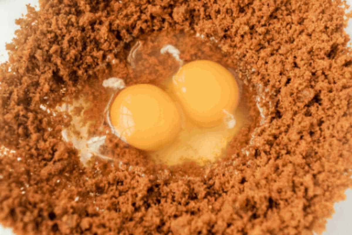 two raw eggs in a coconut sugar mixture.