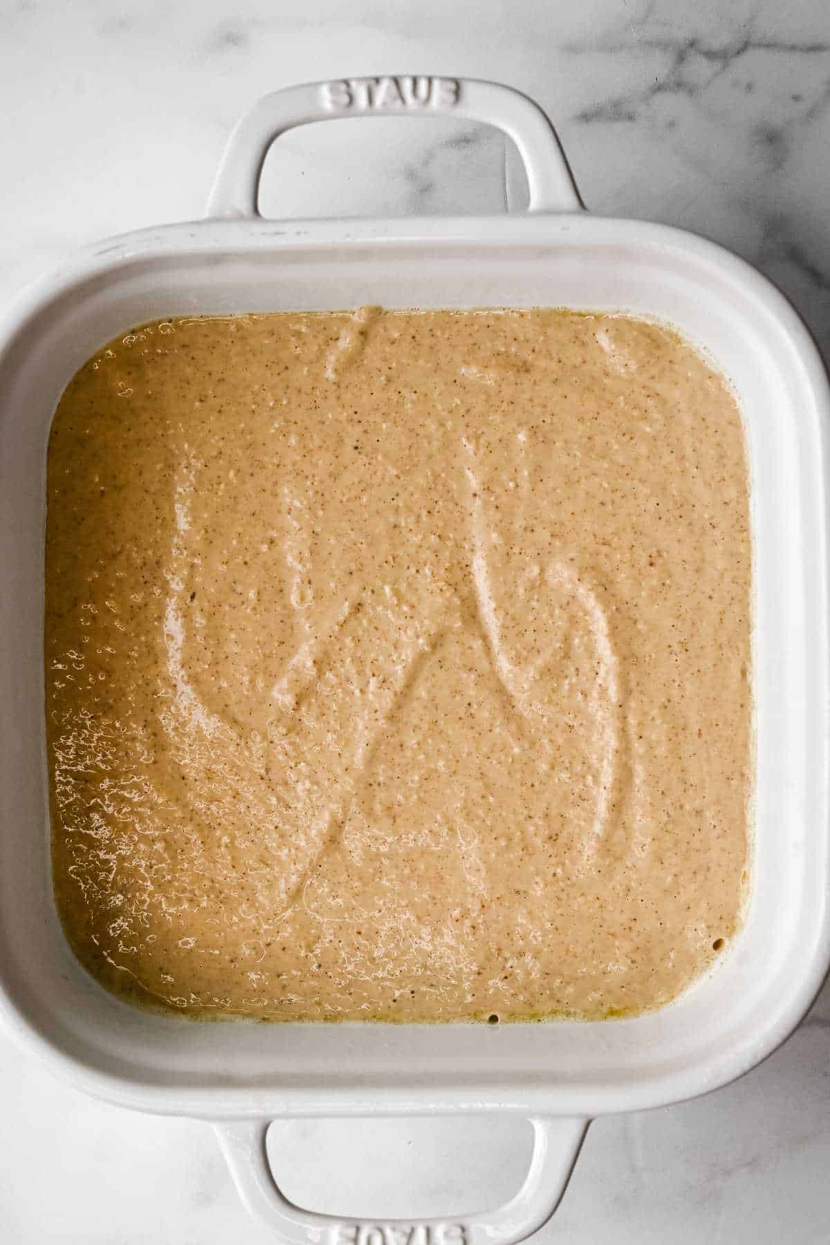 unbaked protein baked oatmeal batter in a white baking dish.