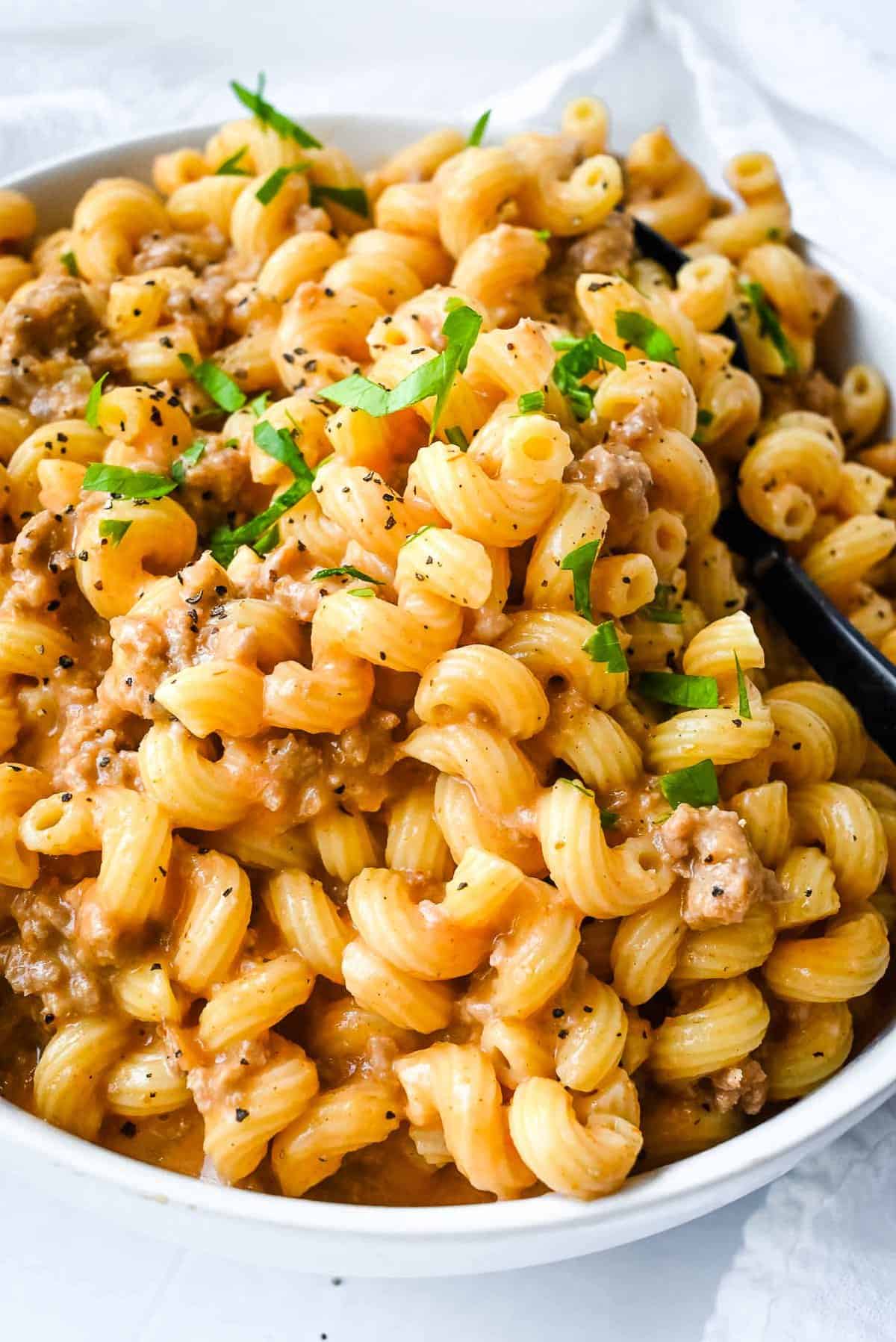 bowl of instant pot hamburger helper topped with parsley.