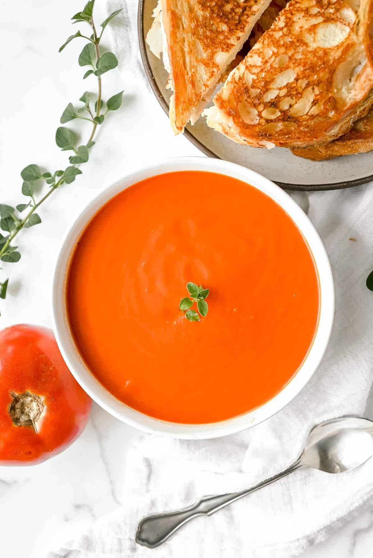 bowl of instant pot tomato soup with grilled cheese