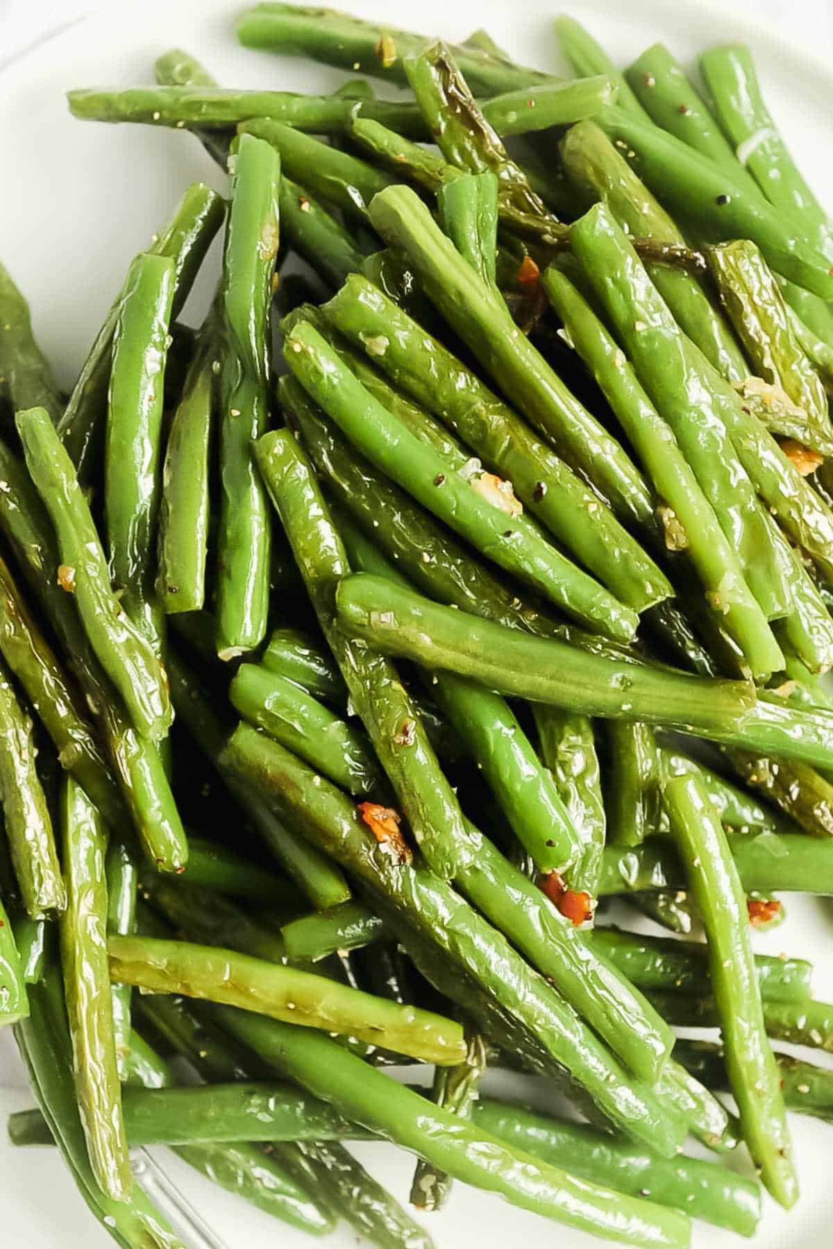 plate of blistered green beans in a pile.