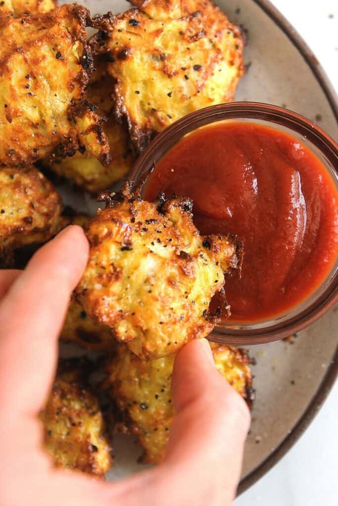 whole30 hash browns dipped in ketchup