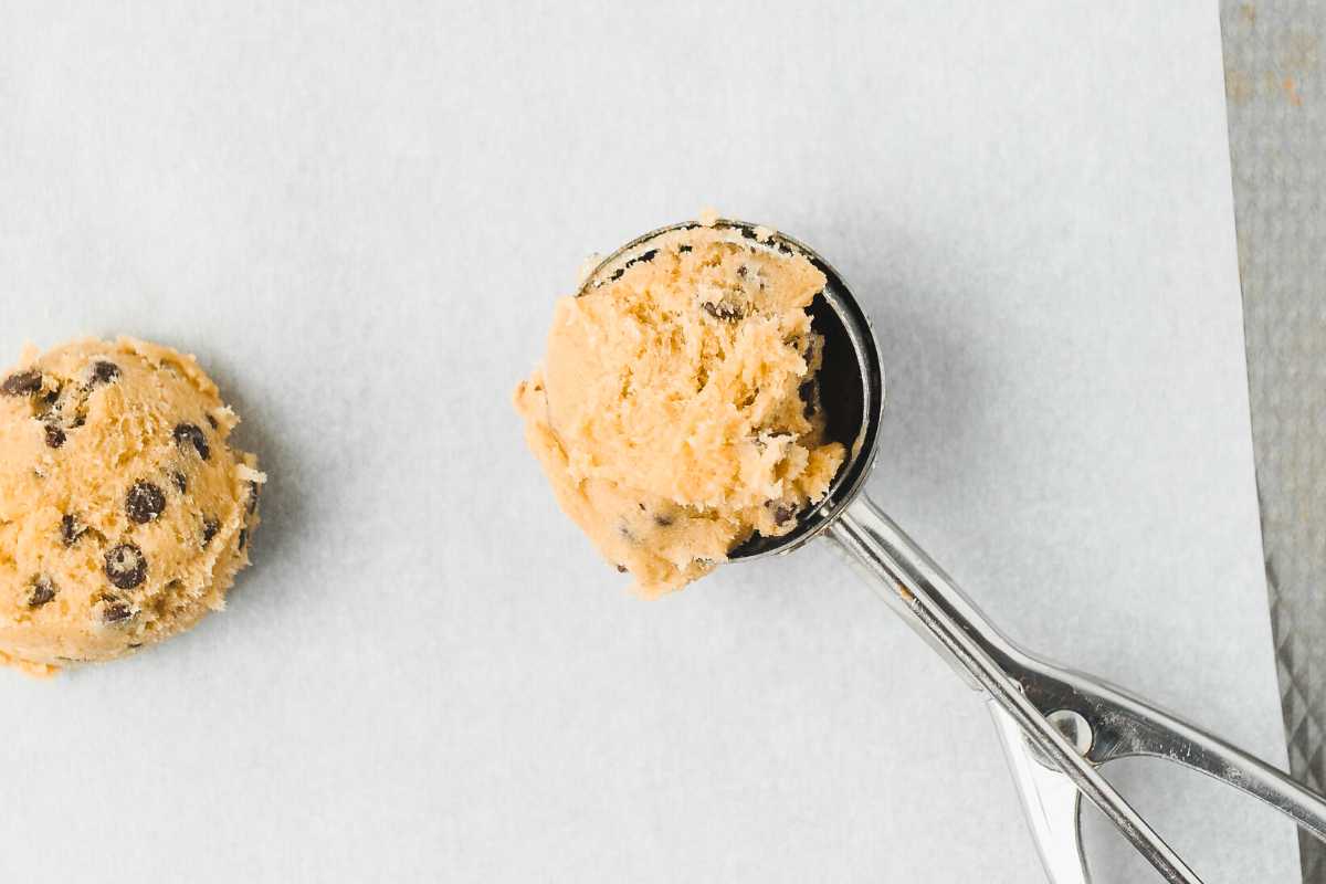 oat flour chocolate chip cookie dough in a scoop on parchment paper.
