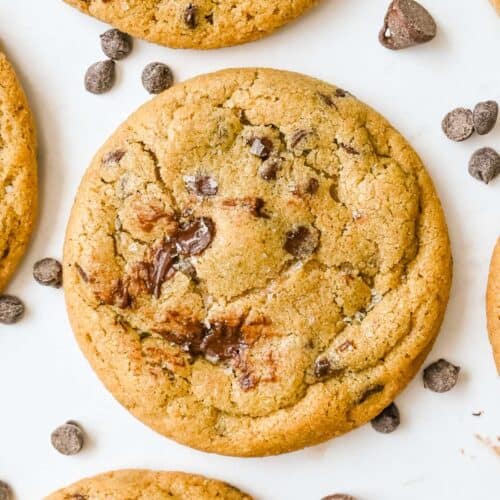 close up shot of oat flour chocolate chip cookies on a white background.