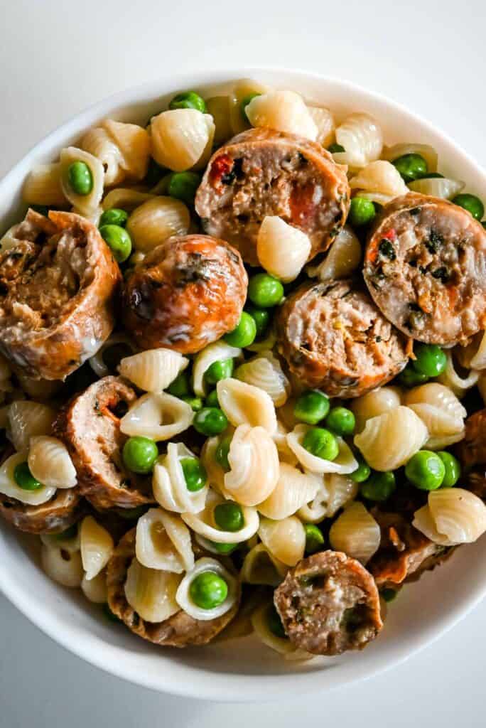 bowl of air fryer sausage with macaroni and cheese and peas