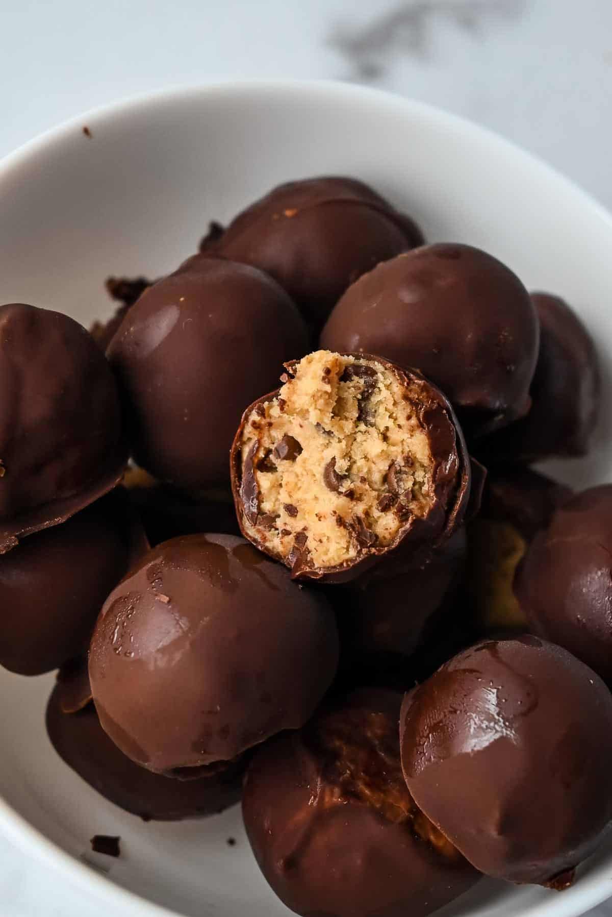 bowl of no bake cookie dough bites covered with chocolate