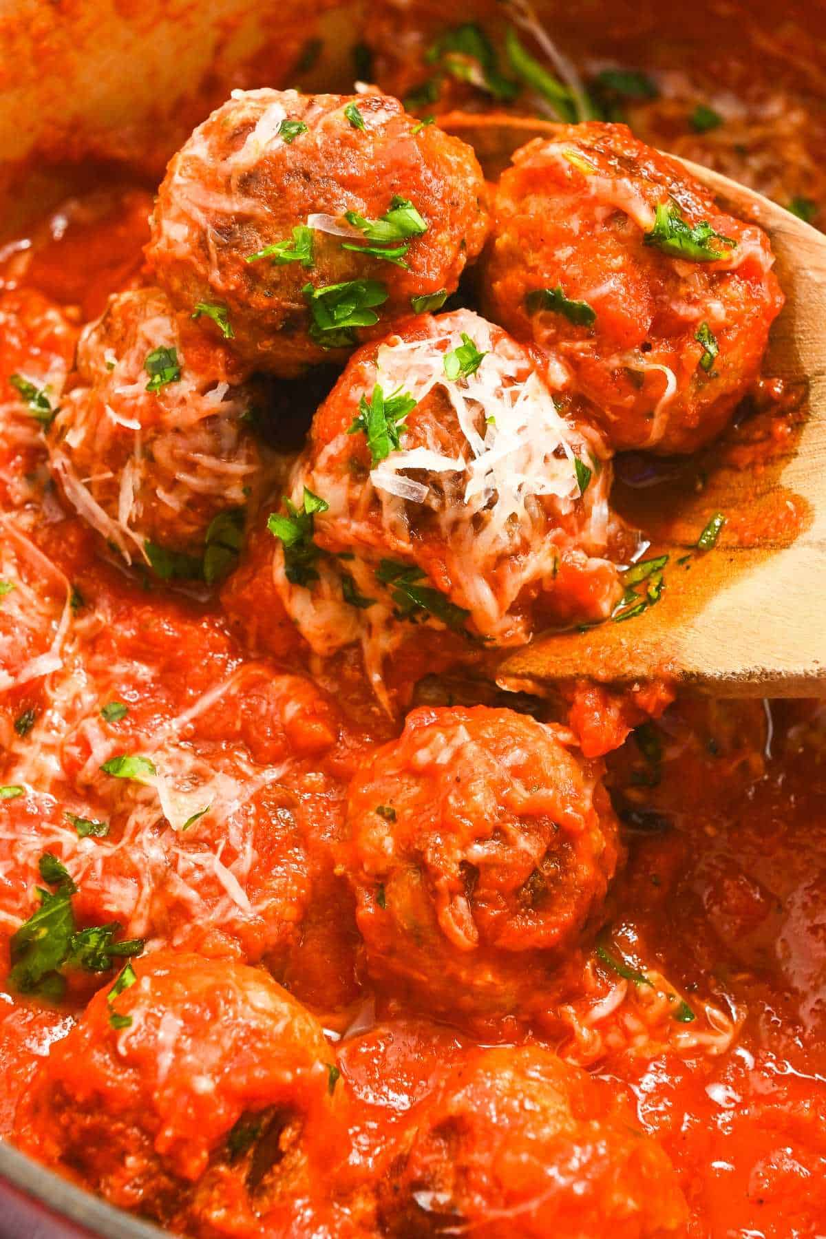 eggless meatballs in red sauce topped with parsley and parmesan cheese.