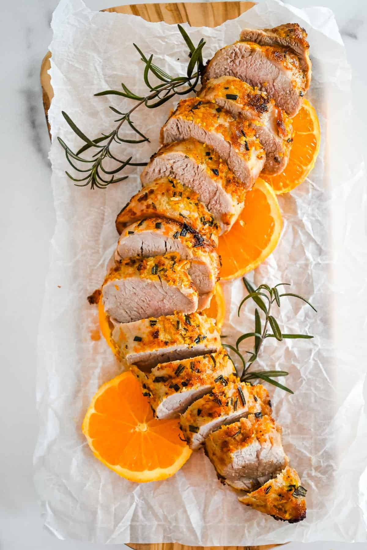 slices of air fryer pork with oranges and rosmeary