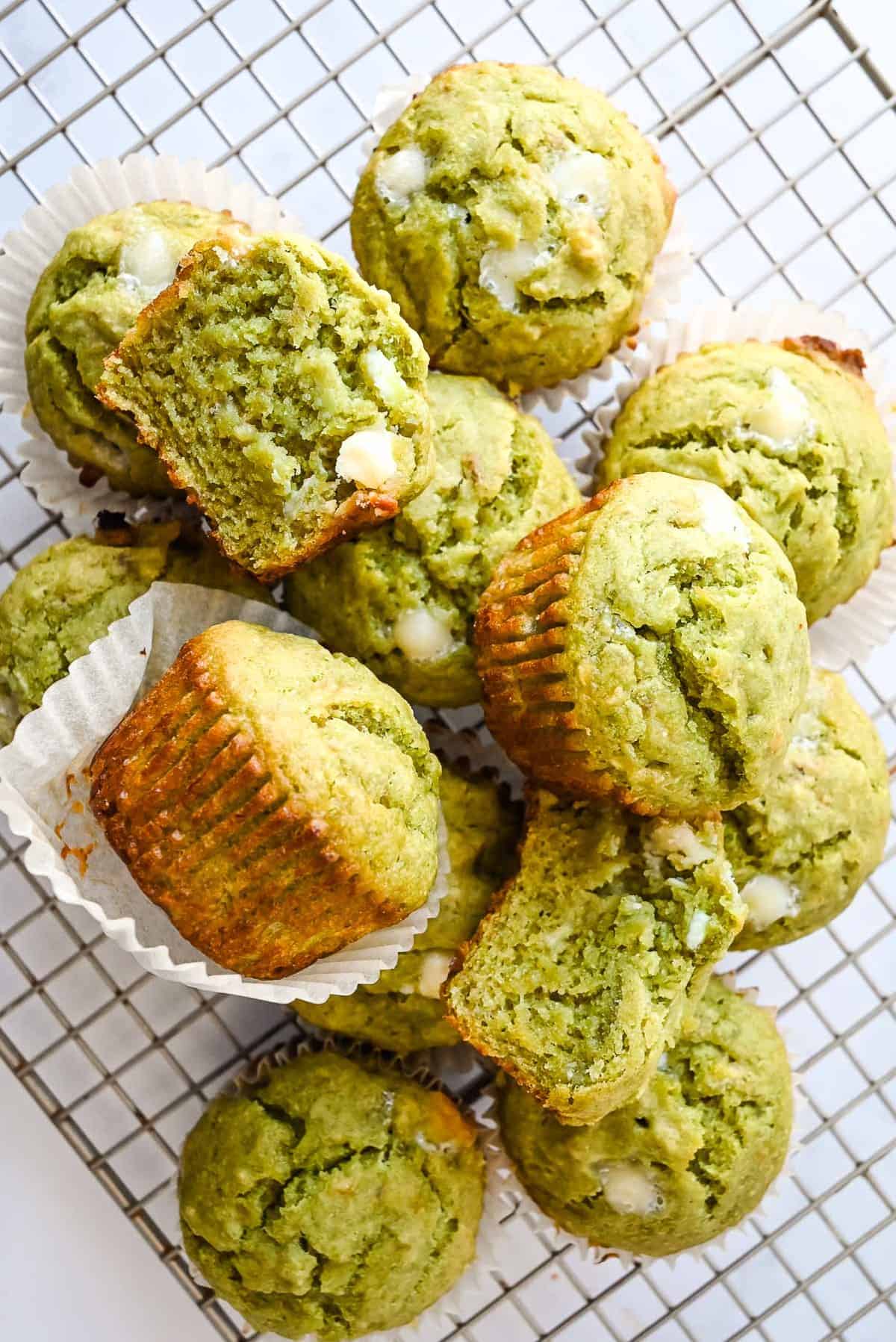 matcha muffins on a cooling rack in a pile
