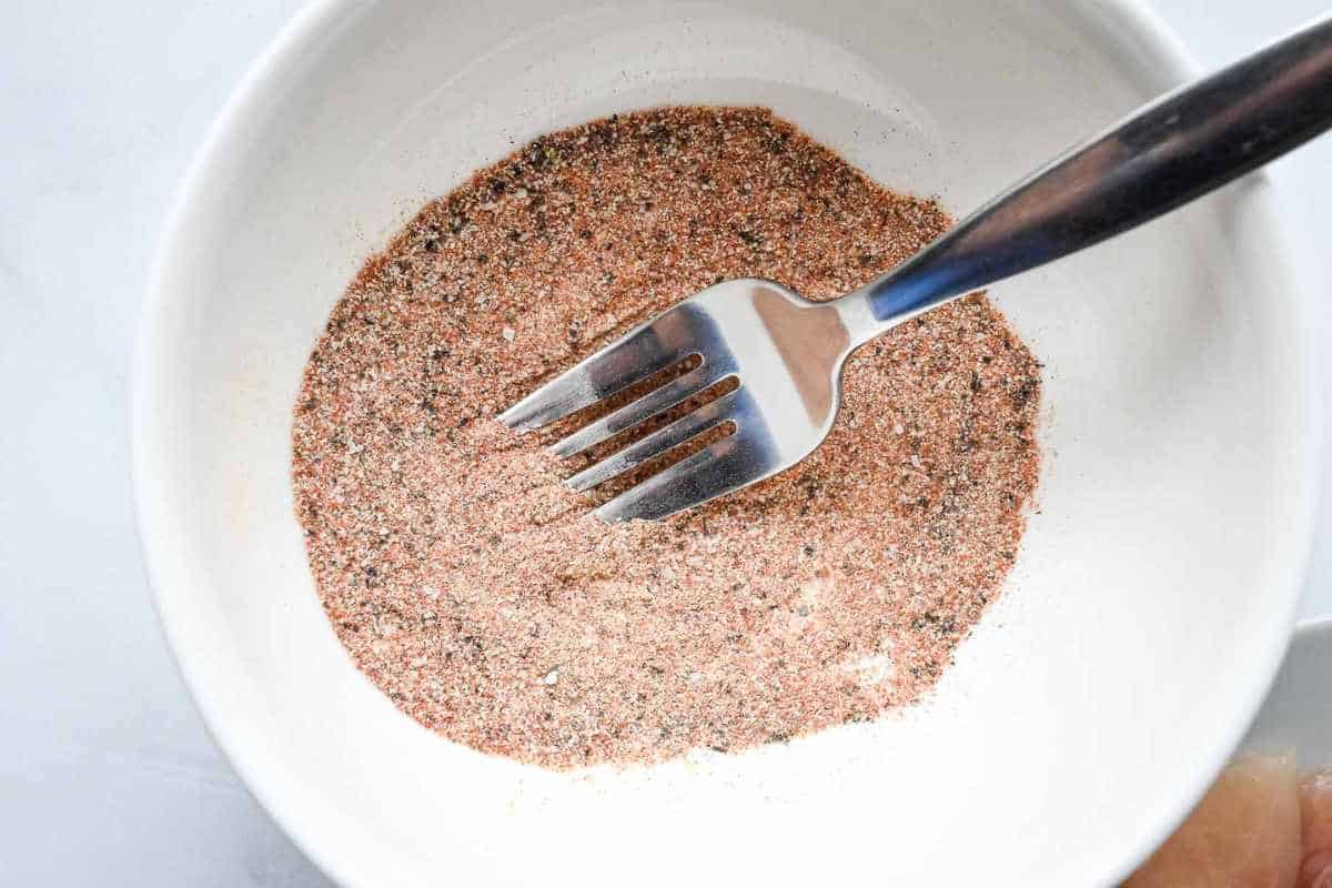 close up shot of chicken seasoning in a white bowl.