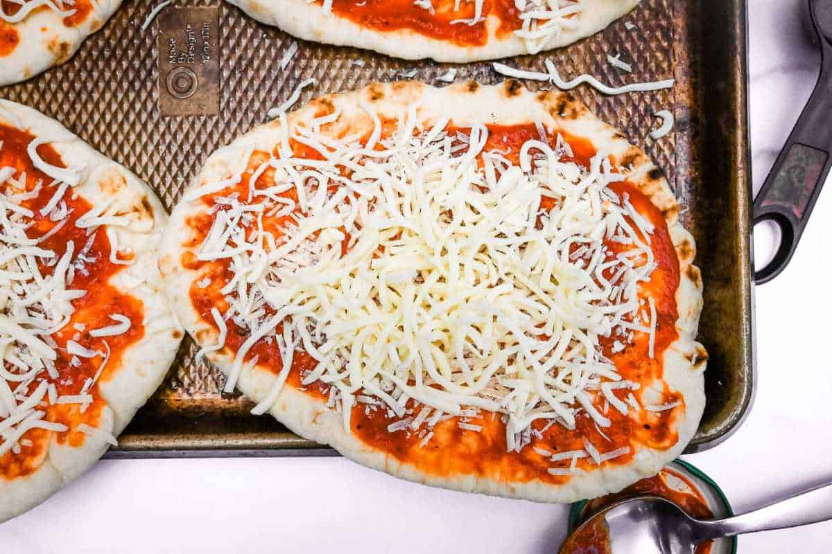 naan bread pizza topped with cheese.