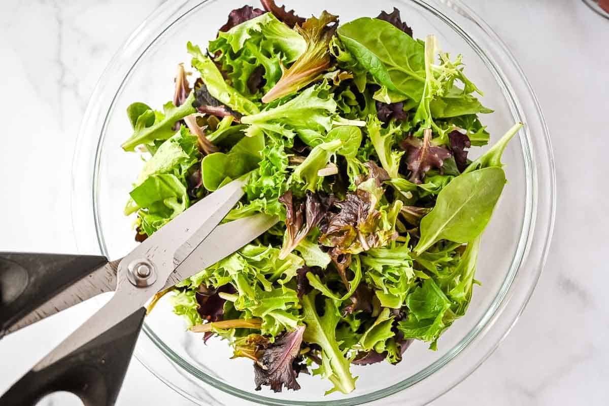 bowl of spring mix with kitchen shears