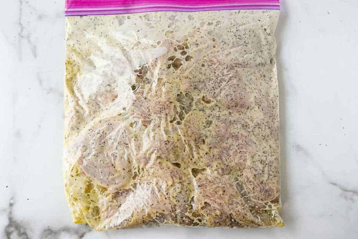 sealed ziploc bag with marinated Greek yogurt chicken.