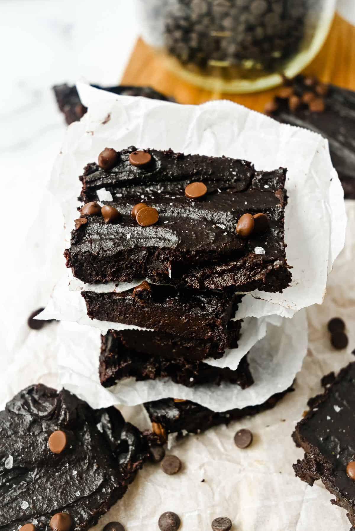 slices of sweet potato brownies stacked on parchment paper.