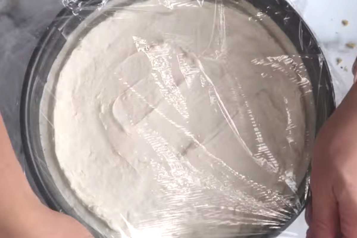 keto cheesecake covered with plastic wrap.