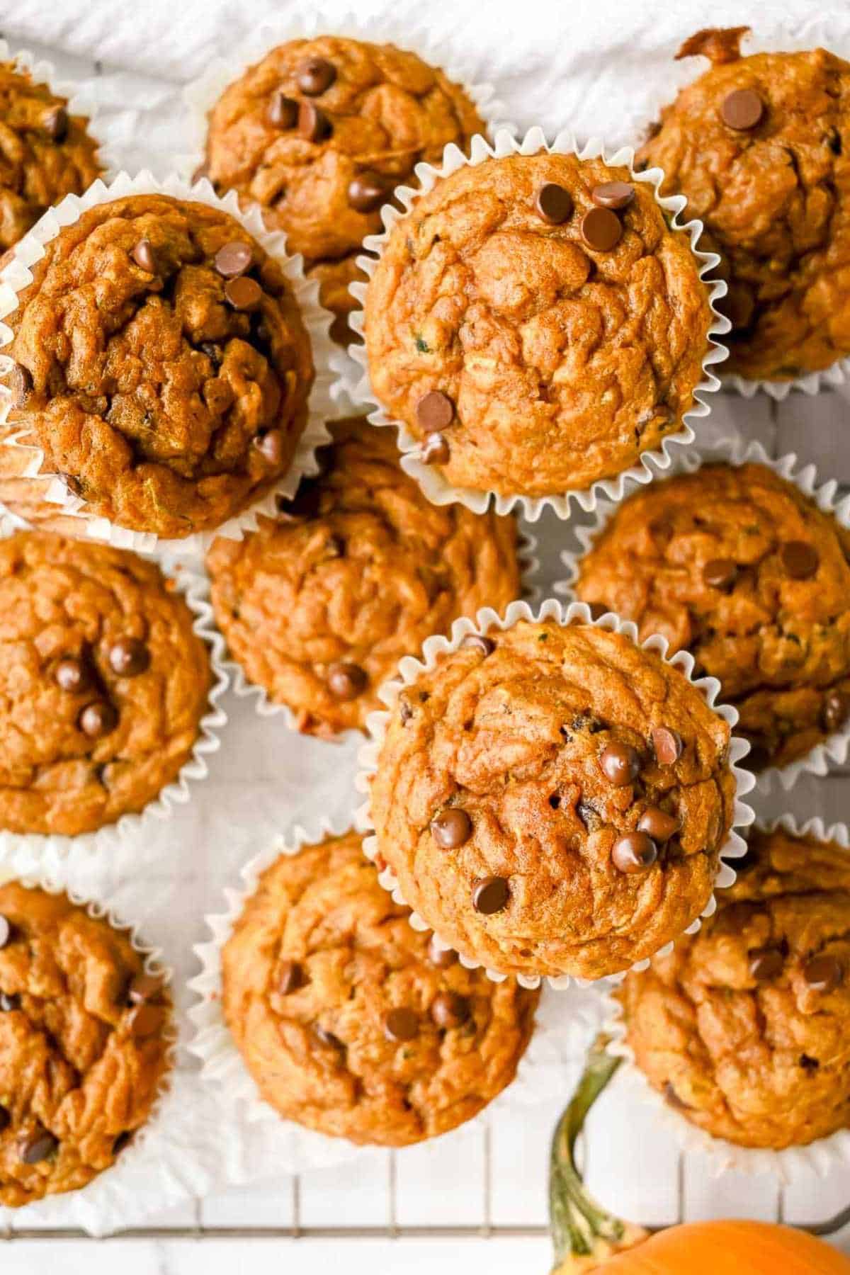 pile of pumpkin protein muffins on a white background.