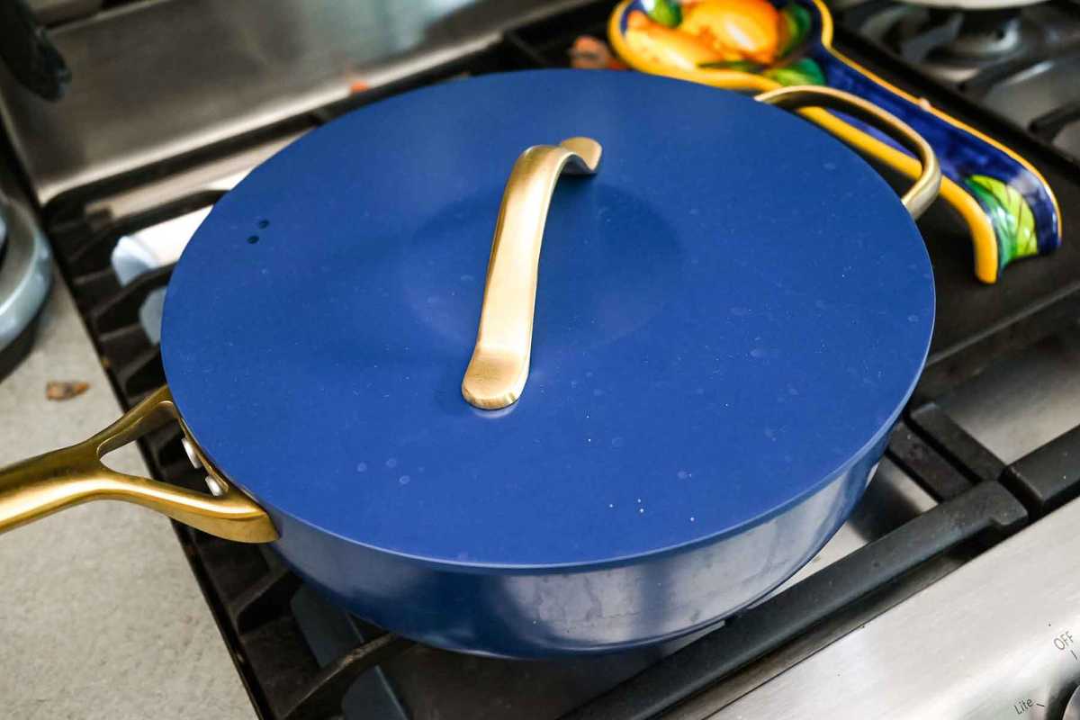 blue skillet with a lid on the stove.