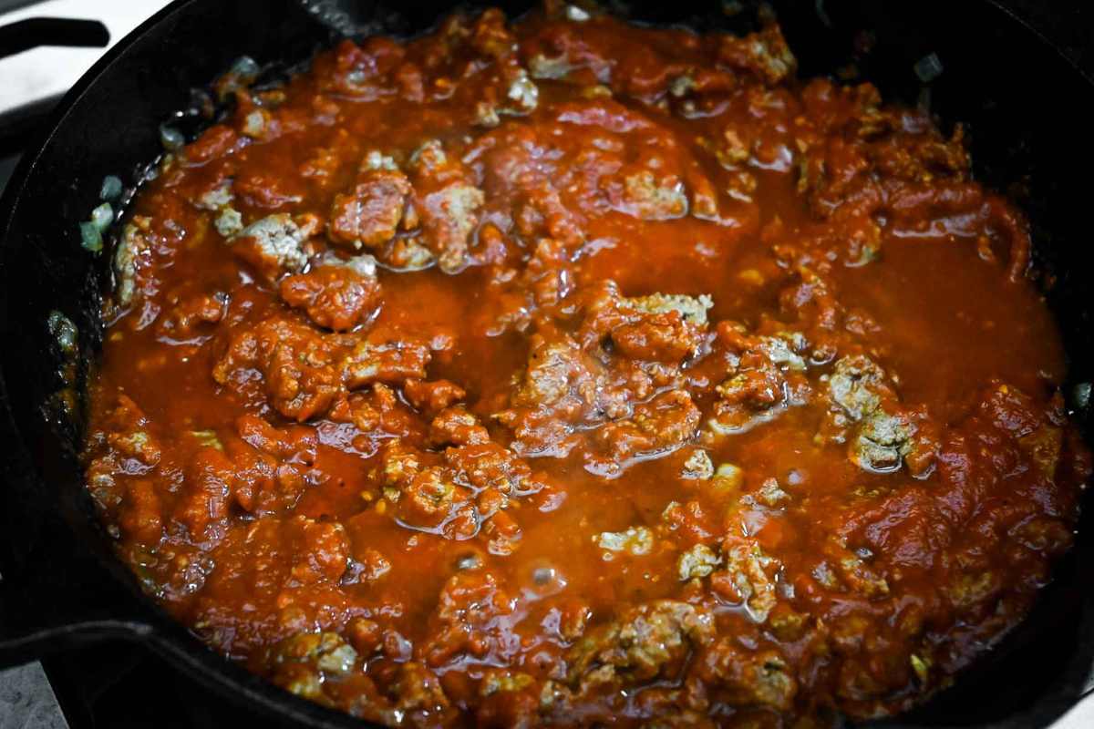 close up of meat sauce in a cast iron skillet.