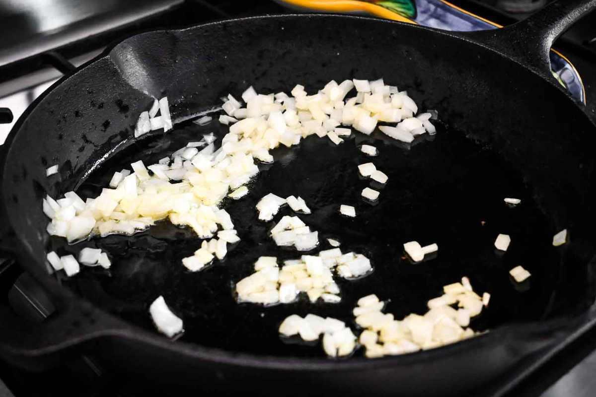 onions sautéing in a cast iron skillet.