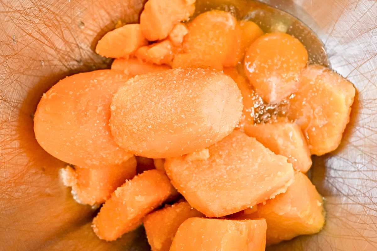 canned sweet potatoes in a silver mixing bowl.