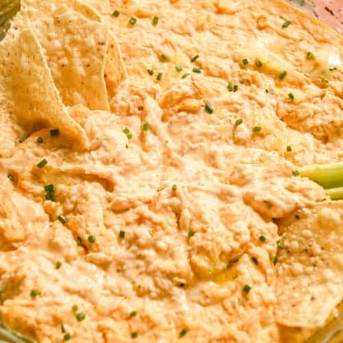 close up of Greek yogurt buffalo chicken dip with tortilla chips and celery.