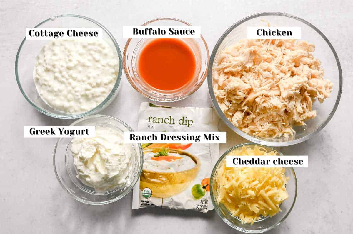 labeled ingredient photo of buffalo chicken dip ingredients on a white background.