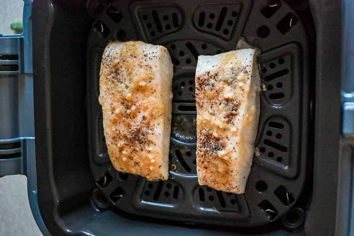 cooked air fryer halibut in basket.