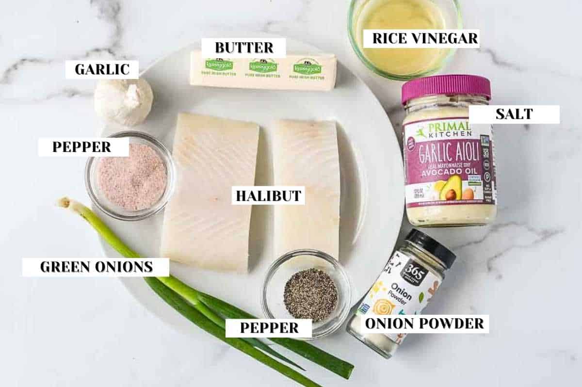 ingredients for this air fryer halibut recipe on a white marble background.